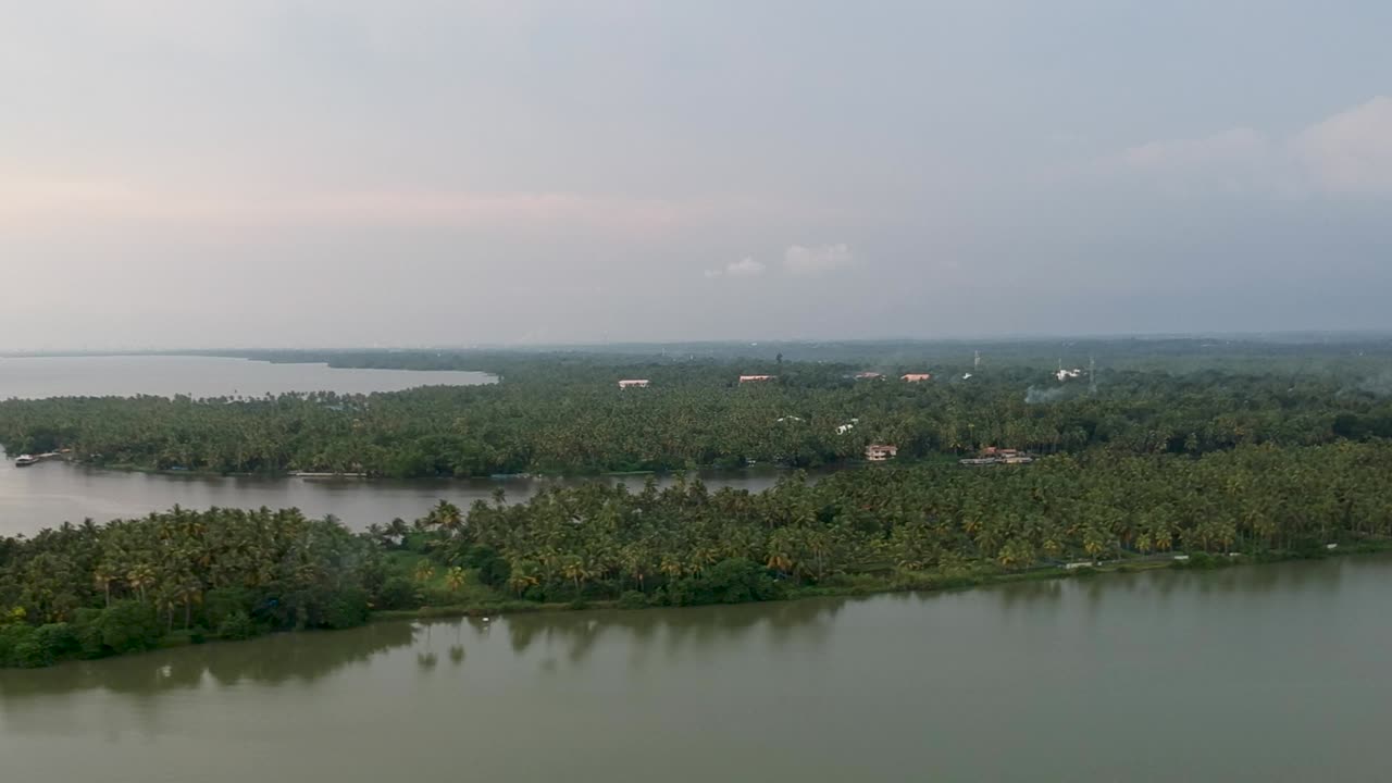 Beautiful aerial shot of a backwater Vembanadu Lake , sunset,coconut trees ,water transportation,water lines,twilight