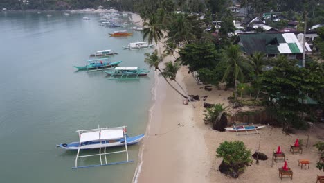 Calm-morning-and-empty-beach-at-tropical-fishing-village,-Port-Barton