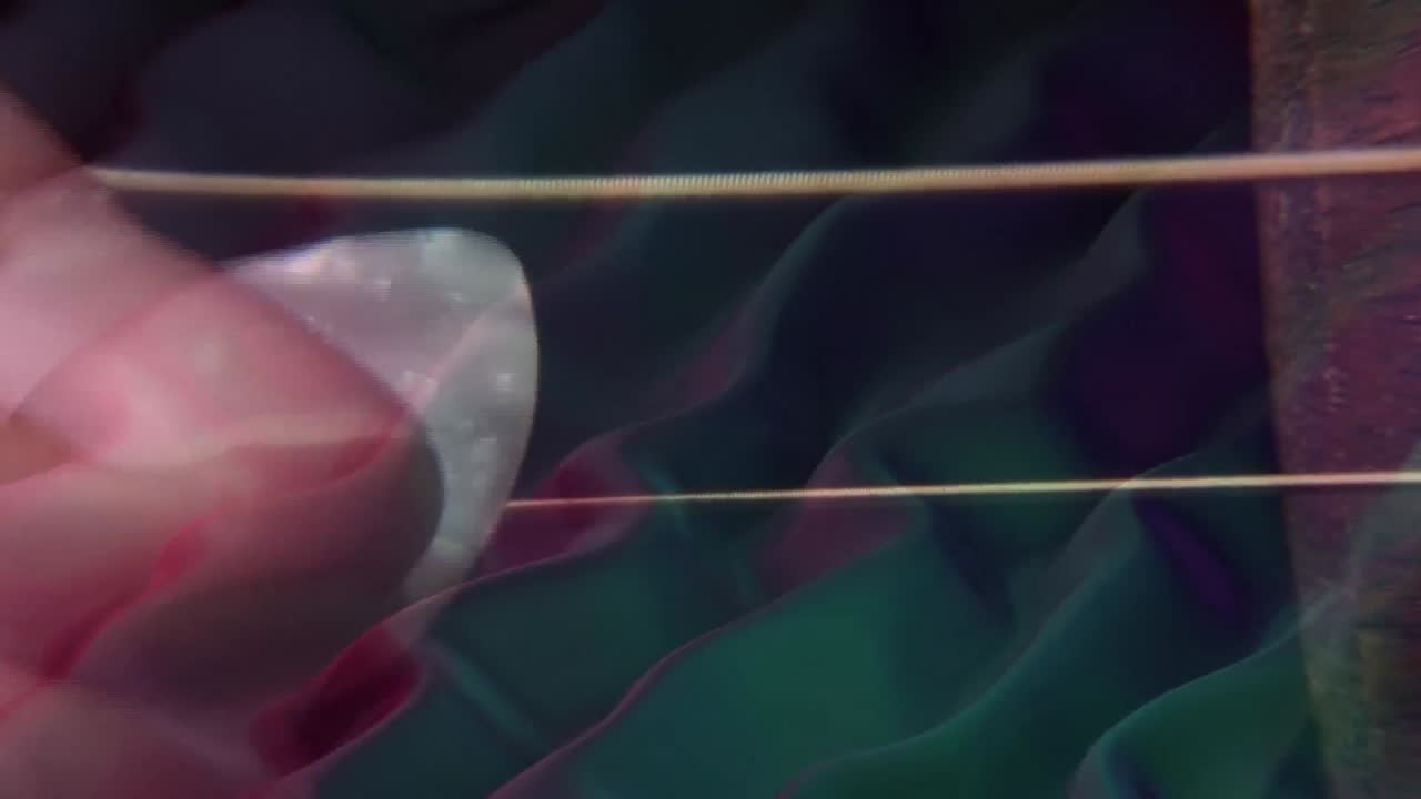 Multiple waves flowing against close up of person playing guitar