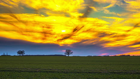 el sol amarillo dorado detrás de nubes gigantes el lapso de tiempo al atardecer sobre el campo de hierba