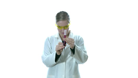 With-a-look,-a-woman-in-the-laboratory-examine-the-red-liquid-in-the-tube-to-assure-that-it-is-the-correct-measure