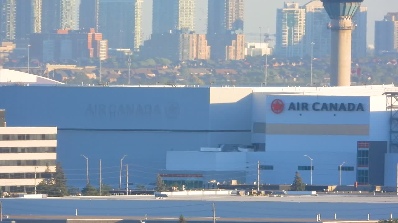 Airplane taking off from a Toronto runway with city skyscrapers in the background, aviation departure