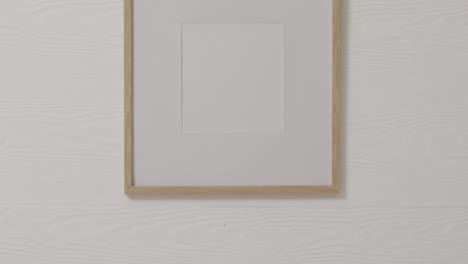 Wooden-frame-with-copy-space-with-white-background-and-white-wall