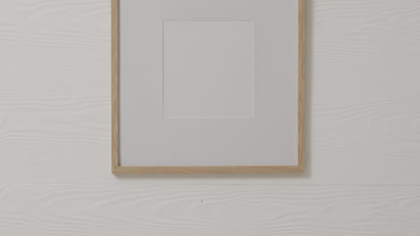 wooden frame with copy space with white background and white wall