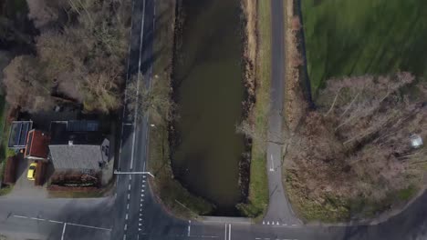 drone shot of beautiful dutch landscape with canal and roads