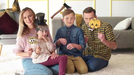 portrait of happy family spending halloween together at home