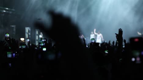 red flashing lights on stage with dj performing modern rhythmic music in front of fans