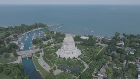 aerial footage of the baháʼí house of worship with lake michigan in the background