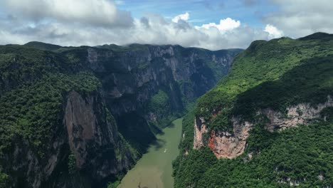 tour boat on the grijalva river in the sumidero canyon n sunny chiapas, mexico - aerial view