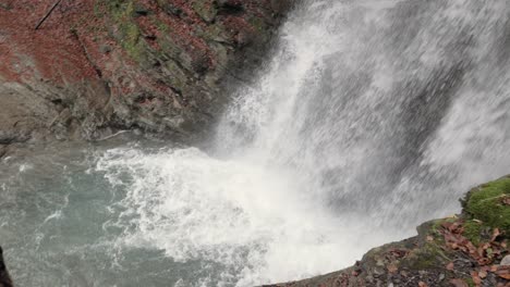 A-splendid-waterfall-in-the-French-Alps,-the-Cascade-de-Nyon,-is-pouring-down-water-in-slow-motion