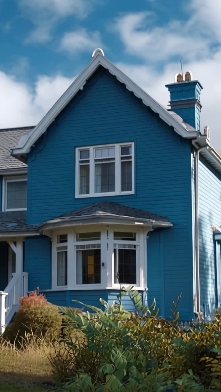 A Vibrant Blue House Displaying a Bright 'For Sale' Sign in Front of a Lush Garden, Signifying a Property Available for Purchase in a Scenic Neighborhood