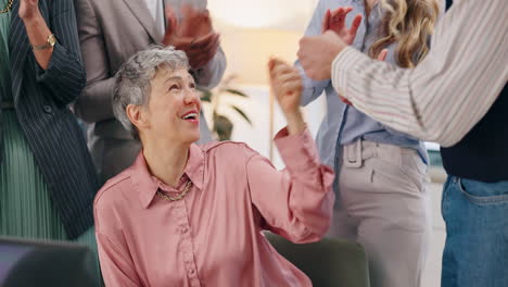 business team celebrating success and applauding a woman