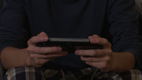 person playing a portable video game console