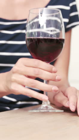 sección media de una mujer bebiendo vino tinto