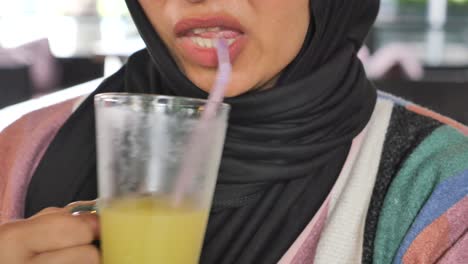 woman drinking juice in a restaurant