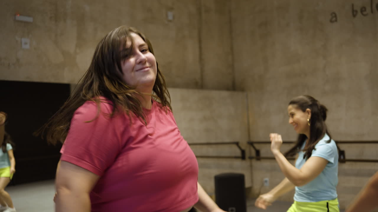 Group of women dancing together indoors