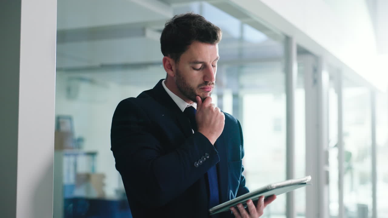 Thoughtful Businessman with Tablet in Office