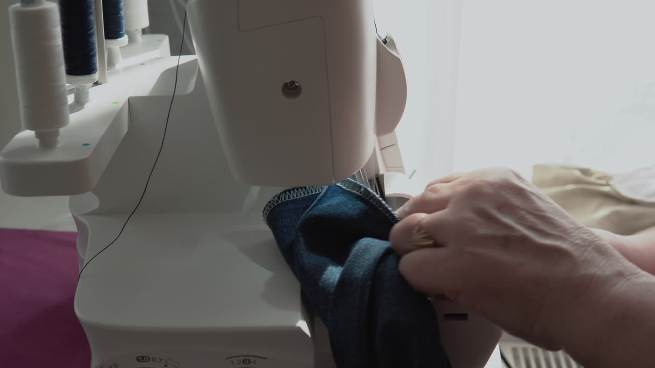 Sewing baby pants on a machine closeup
