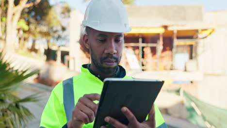 construction worker using tablet at construction site