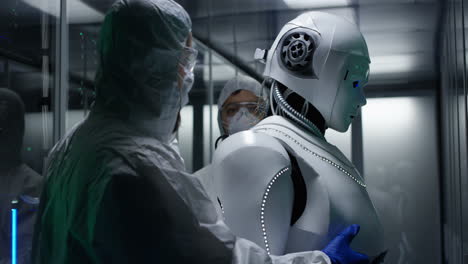 scientists examining a robot in a server room