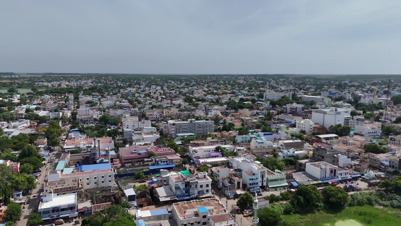 Aerial cityscape highlighting the prominent landmarks of Pudukkottai near a pond.