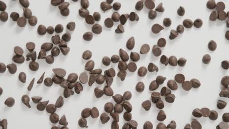 video of overhead view of multiple chocolate chip over white background