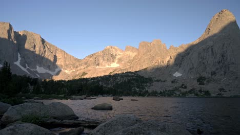 establishing pan across iconic cirque of the towers landscape in the wind river wilderness with alpine lake