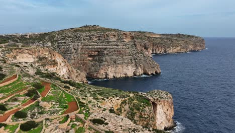 aerial drone shot over blue grotto in malta