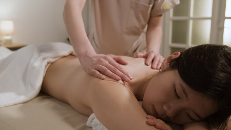 Woman receives a relaxing back massage at a spa