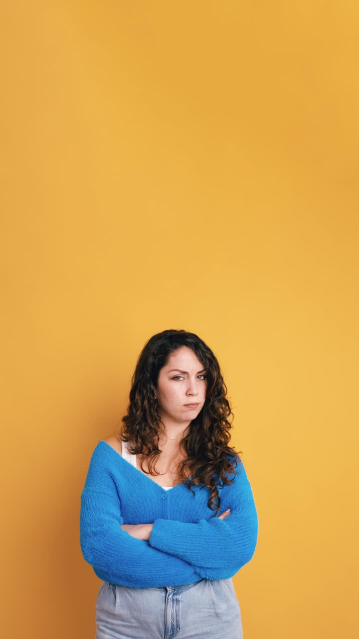 Annoyed Young Woman with Arms Crossed Expressing Disapproval