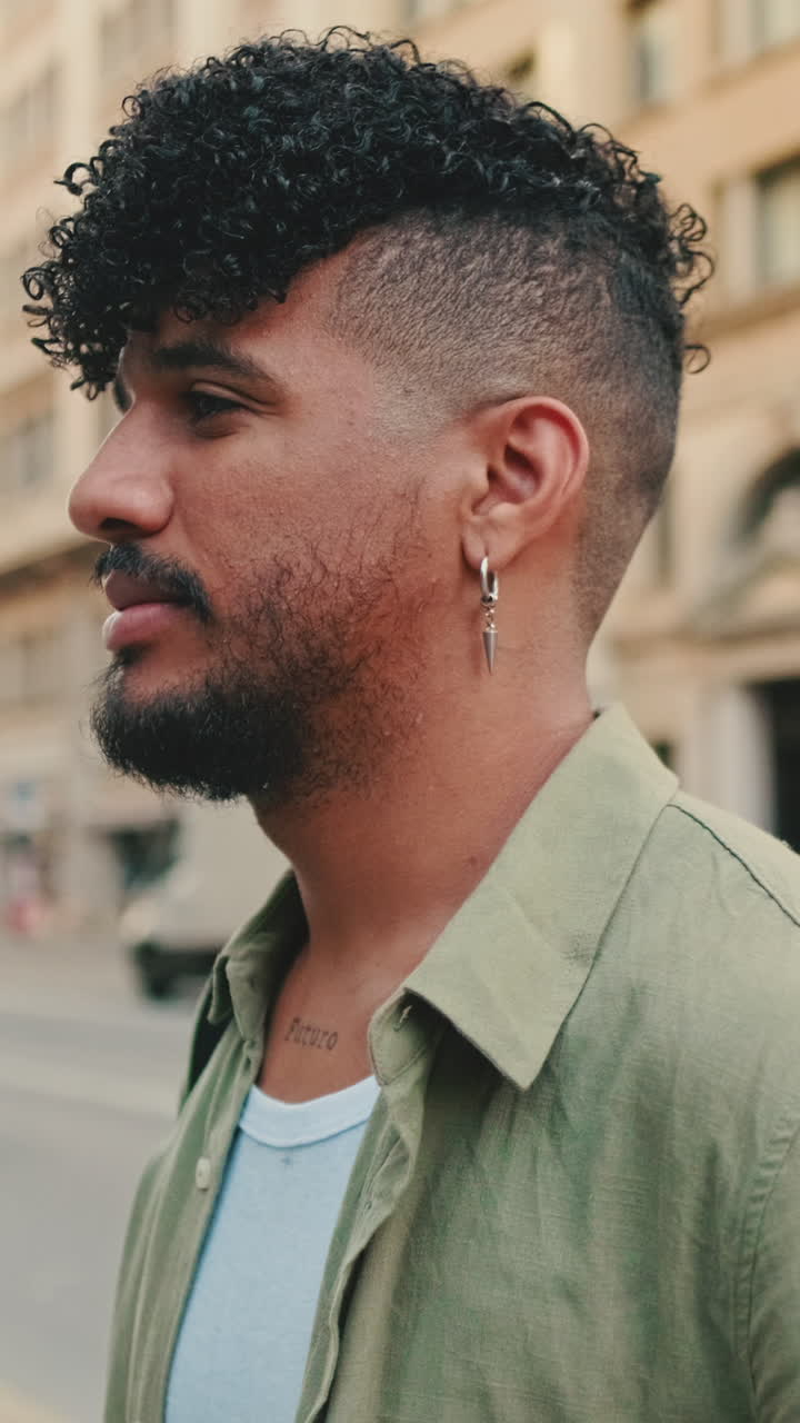 Portrait of a Stylish Man with Curly Hair and Tattoos