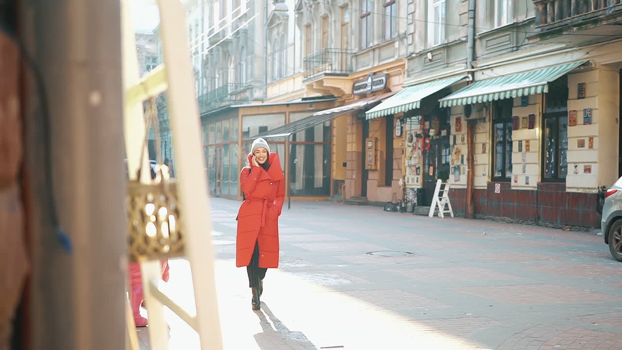 Woman in winter coat talking on her phone in the city