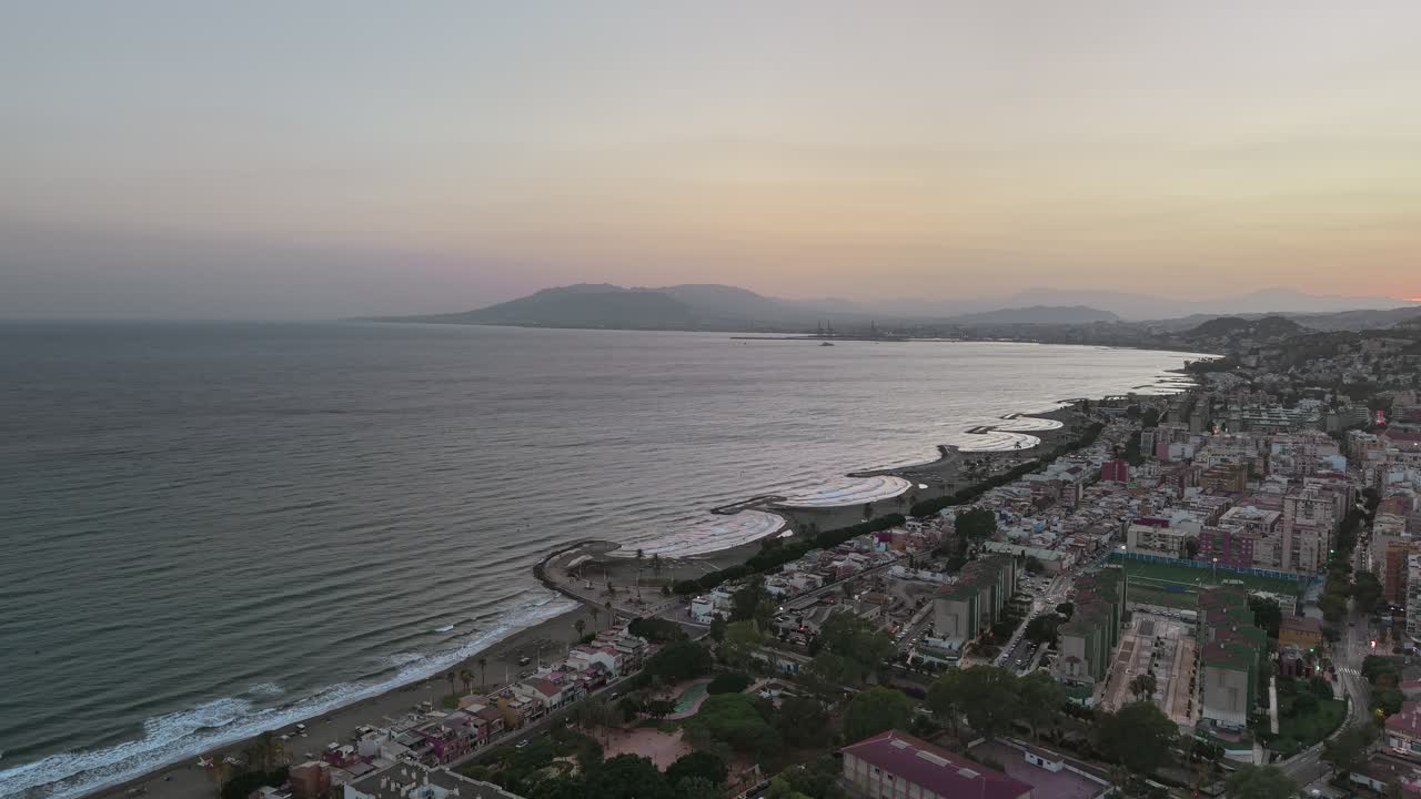 Malaga at dusk, aerial city to beach