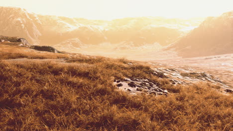 beautiful sunset over mountain range and grassland