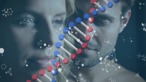 animation of dna strand and molecules over caucasian couple