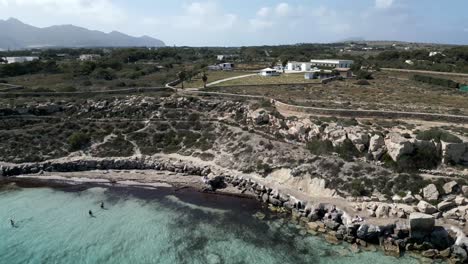 Drone-fly-above-Favignana-island-coastline-Aegadian-Islands-aerial-high-angle-view-of-Mediterranean-Sea-beach