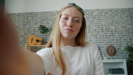 teenage girl taking selfies at home