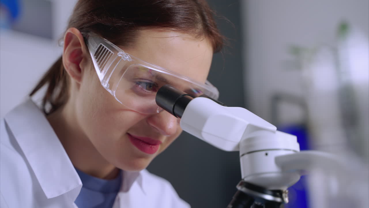 Scientist looking through a microscope