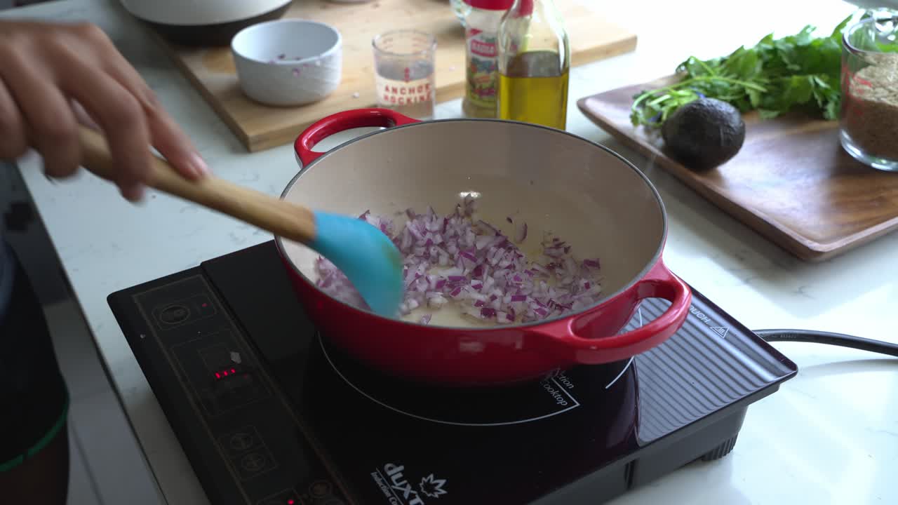 Cooking red onions and special ingredients to cook a meal two cans of beans rice plantain avocado red onion and cilantro