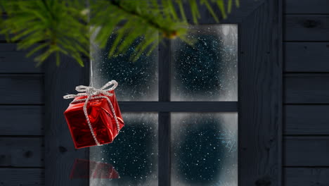 animación de la nieve cayendo sobre el regalo de navidad y la ventana