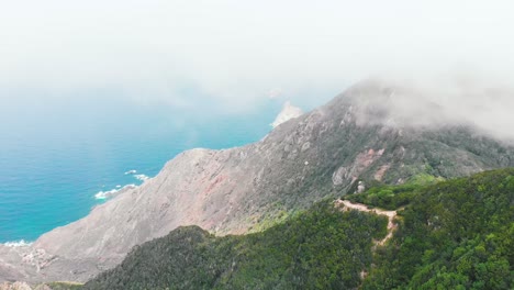 aerial shot of an awesome mountain peak among clouds