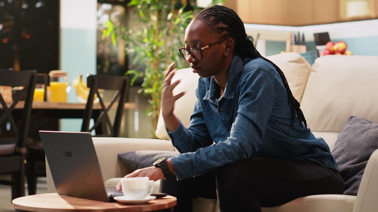 Black woman looking at hour on wristwatch for time management