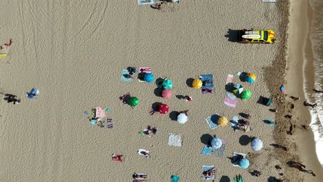 aerial view of a beach with people and umbrellas