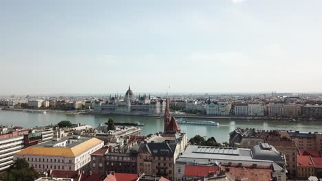 Stunning-drone-shot-of-the-Danube-in-Hungary-and-the-palace-of-parliament-viewed-from-a-distance