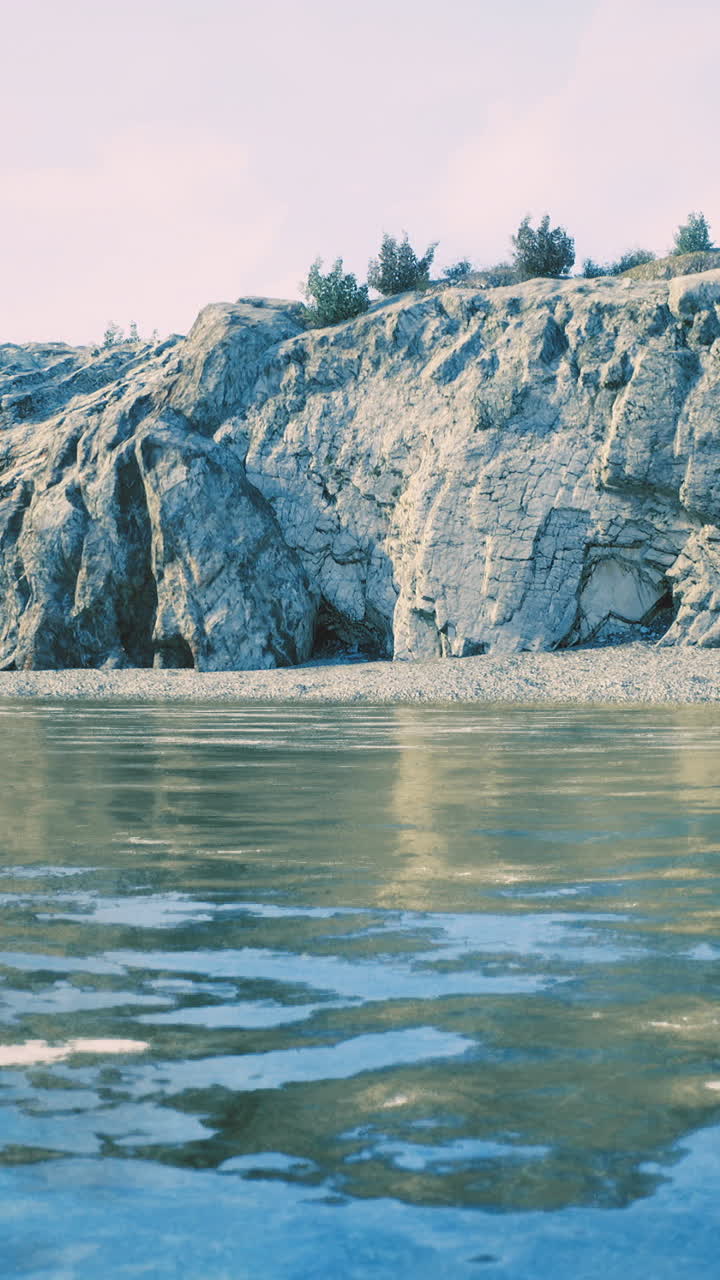 Serene coastal landscape with rocky cliffs and calm water reflecting the sky