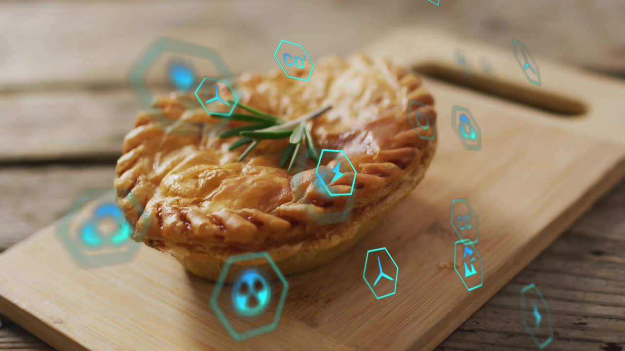 Pie on wooden board with digital icons floating around in animation