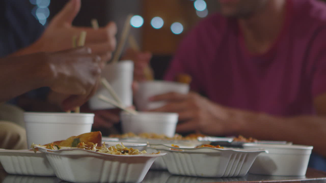Adult friends sharing a Chinese take-away, close up mid section, shot on R3D