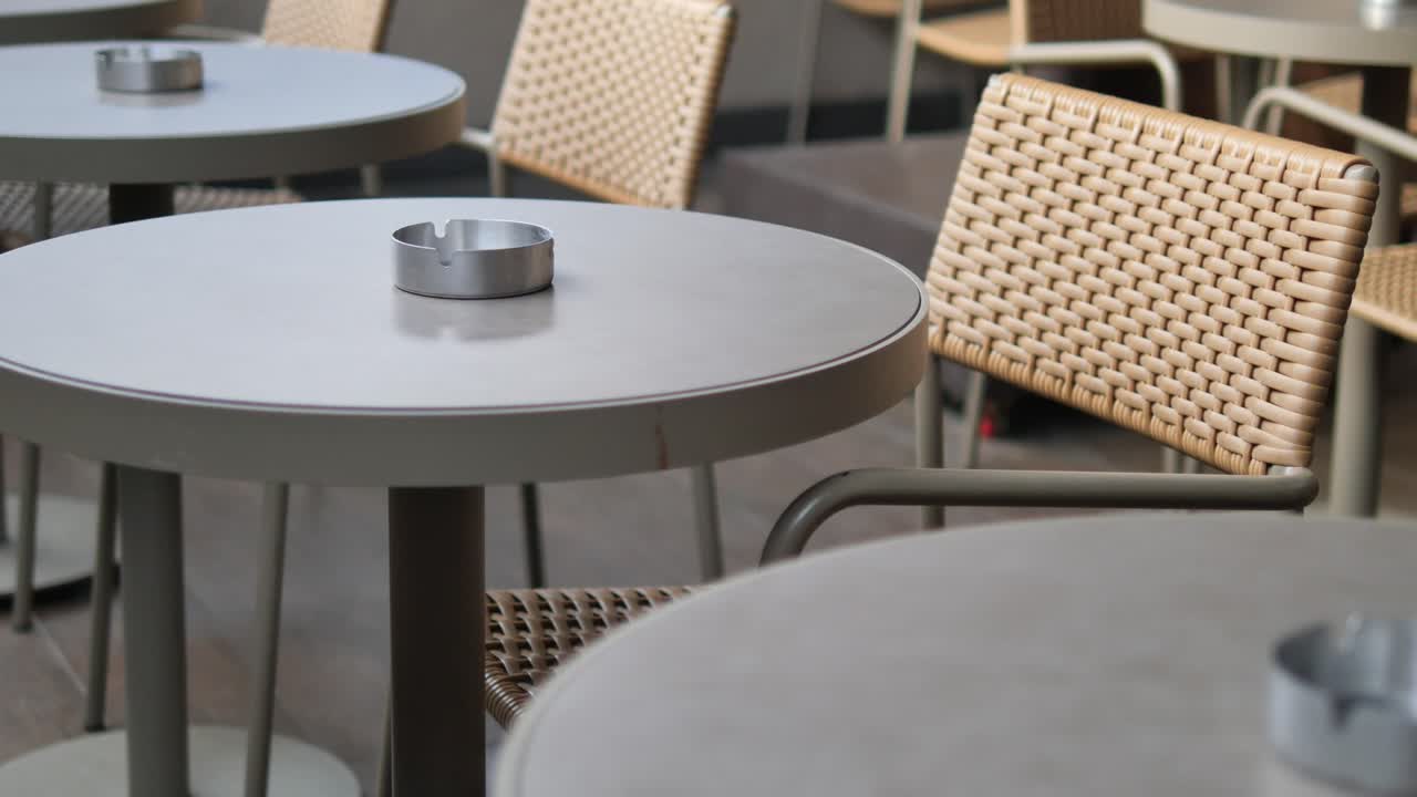 Empty Outdoor Cafe Tables and Chairs on a Quiet Patio