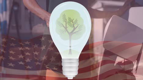 Tree-in-a-bulb-over-flag-of-united-states-and-man-charging-electric-car