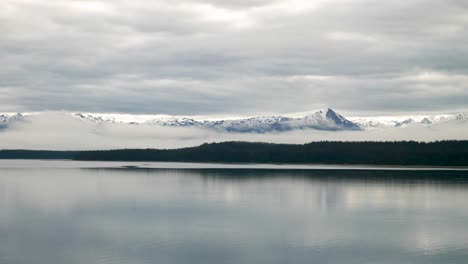 small boat sailing across alaskan waters in the winter